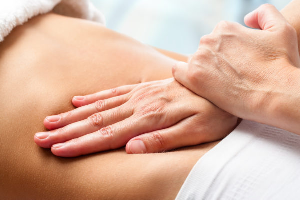 Osteopath at Triple H Osteocare providing gentle treatment for visceral pain relief.
